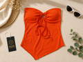 ₹559 Orange strapless ribbed top with a center ring and tie
