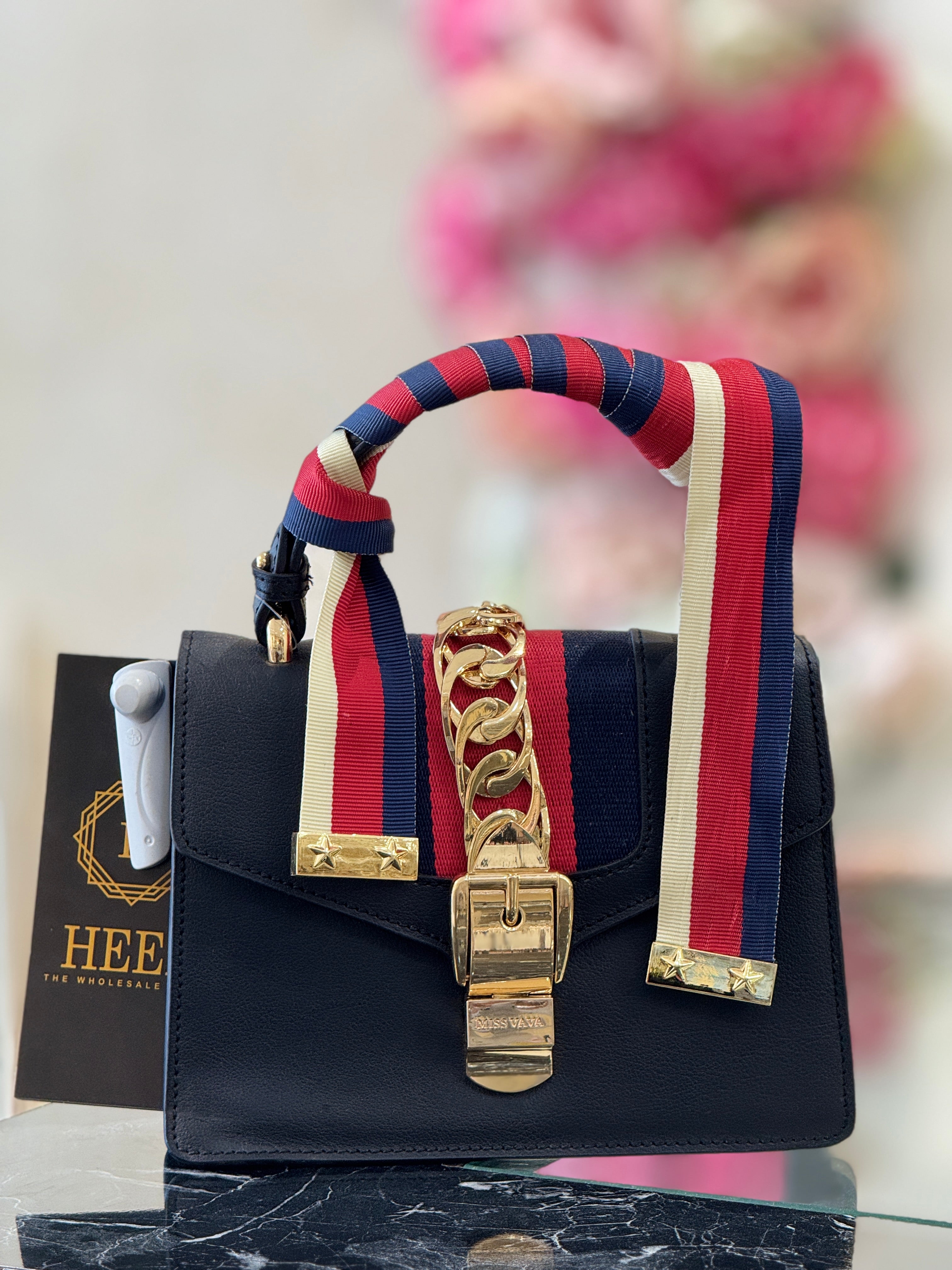 Q562710 black handbag with bold red stripe detailing