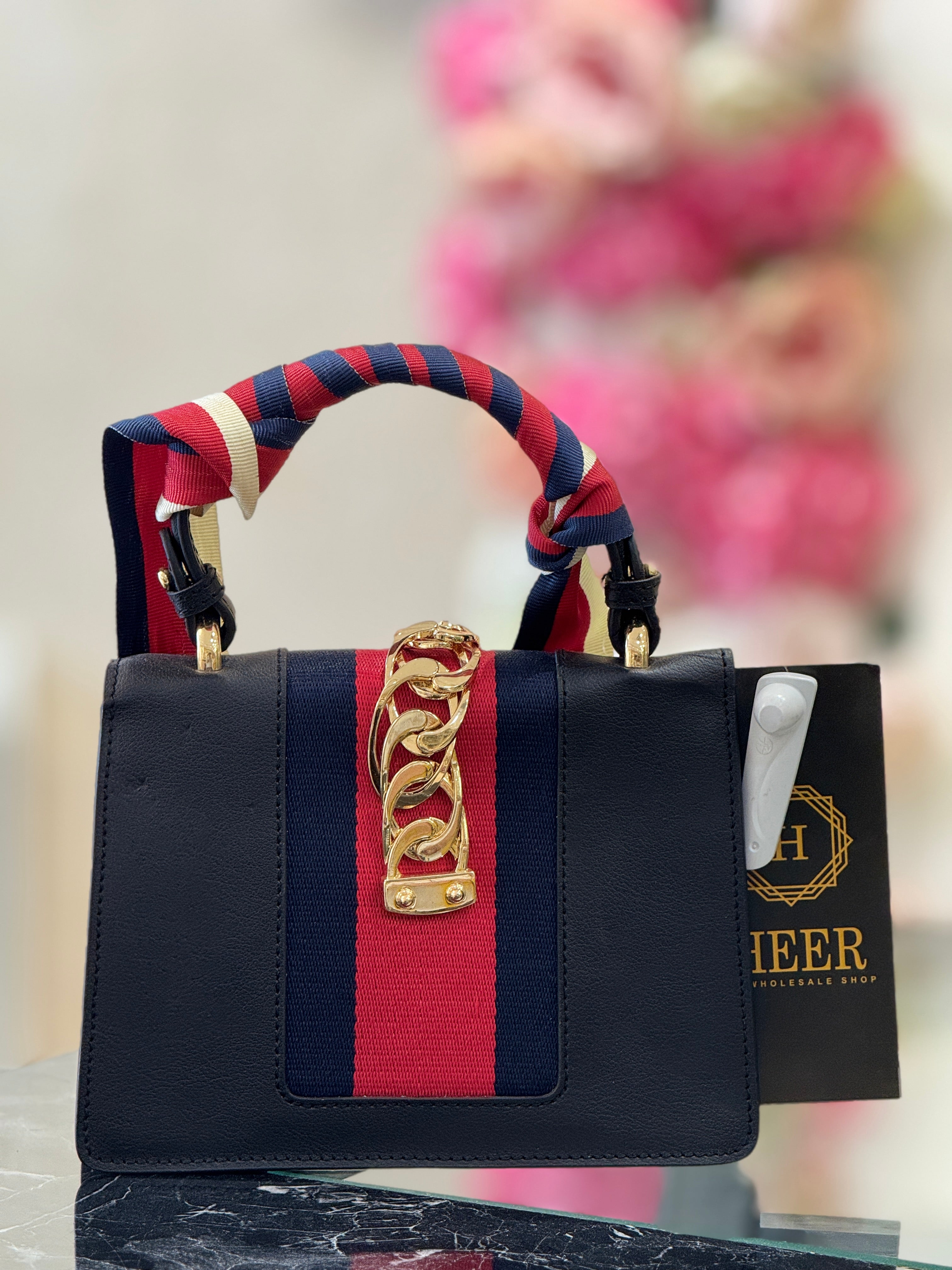 Q562710 black handbag with bold red stripe detailing