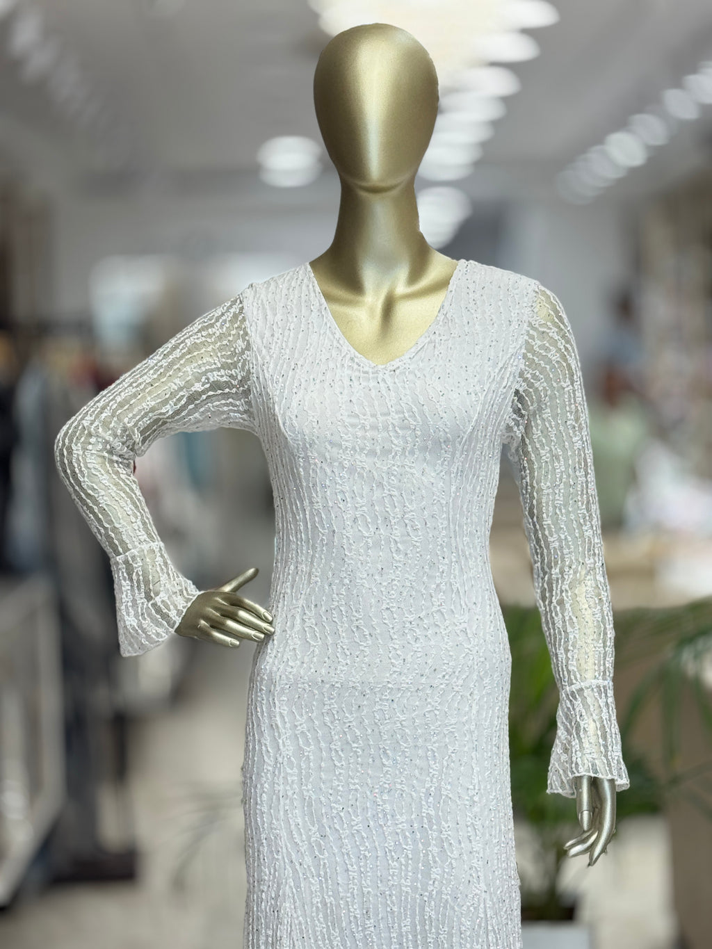 Q562312 Elegant white embellished gown with fringe detailing and statement sleeves.