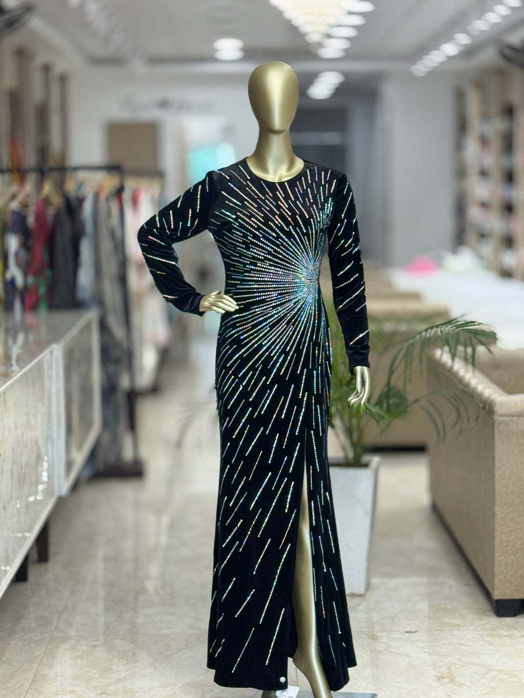 Q562152 Elegant black sequin gown with dazzling starburst detailing and a sleek front slit